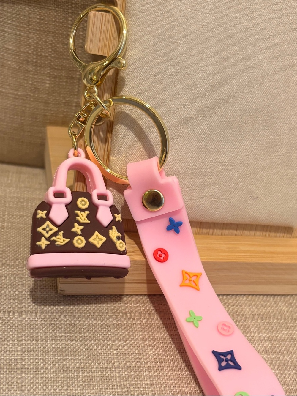 Louis Vuitton Pink Silicone Strap Keychain with Brown Logo Charm